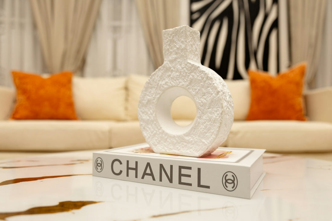 White textured vase on a chanel book, modern interior
