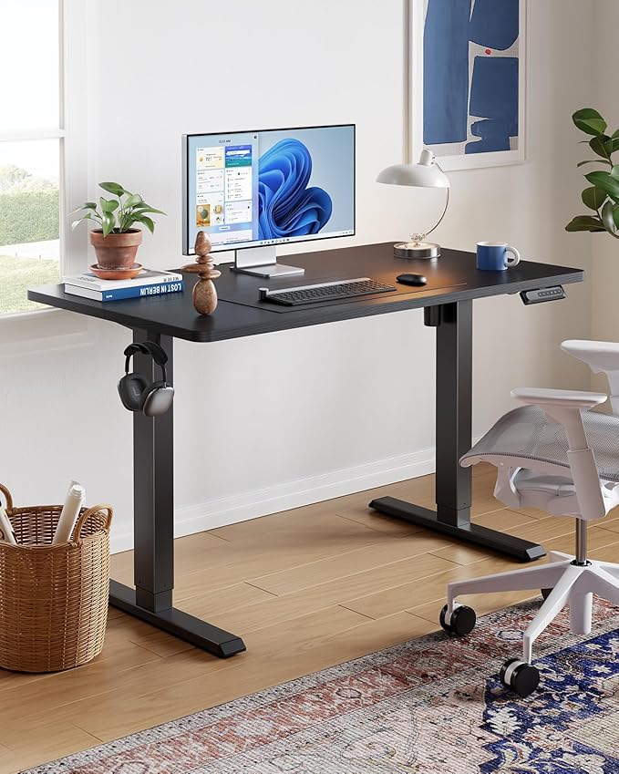 HUANUO 55" x 28" Electric Standing Desk Adjustable Height, 4 Memory Height Settings, Headphone Hook, Cable Manager, Sit Stand Up Desk for Home Office & Computer Workstation, Black